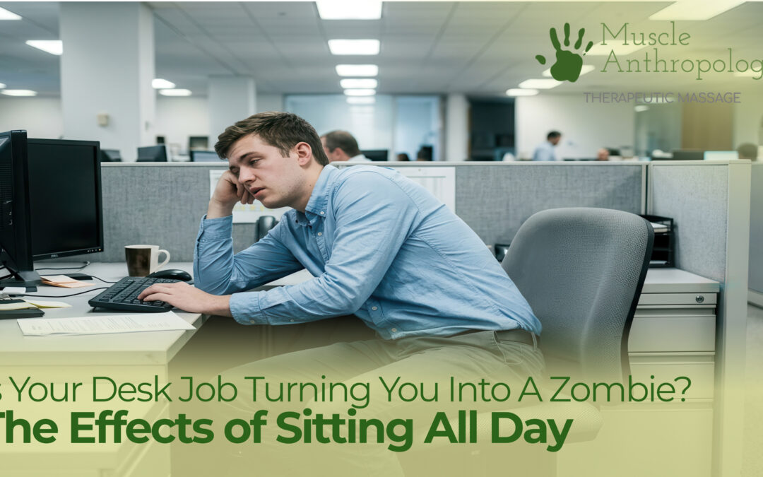 Office worker sitting at desk with hunched over shoulders.